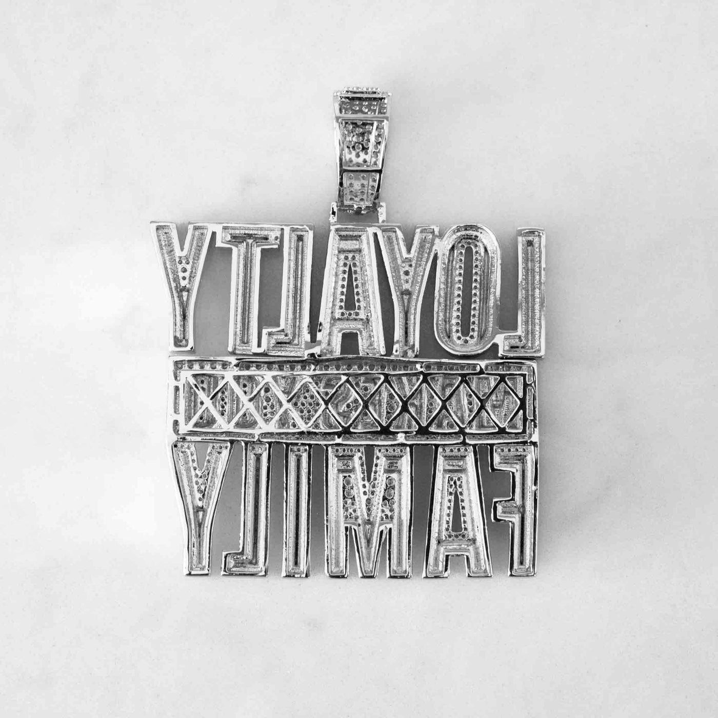 Back of iced out loyalty makes you family pendant in white gold color  